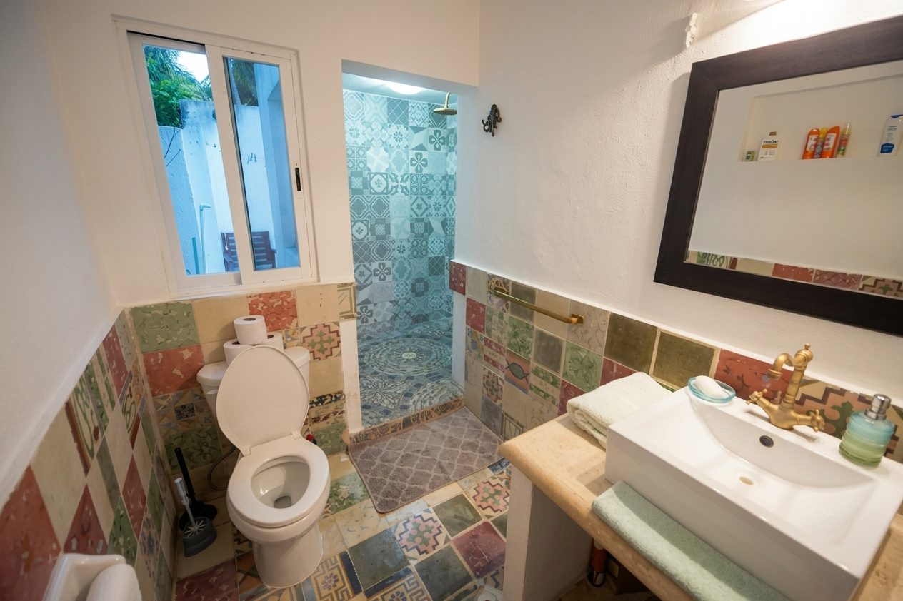 Apartment 1 private bathroom with walk-in shower and Yucatan tilework